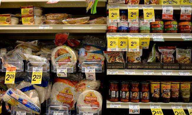 Tortillas and other items are seen in the International food aisle of a grocery store Wednesday, Oct. 16, 2013 in Washington. These days, tortillas outsell burger and hot dog buns; sales of tortilla chips trump potato chips; and tacos and burritos have become so ubiquitously “American,” most people don’t even consider them ethnic. (AP Photo/Alex Brandon)