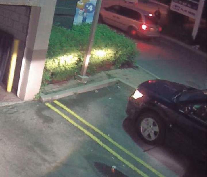Police surveillance of Ford and Lisi with packages at a Scarlett Road gas station - image