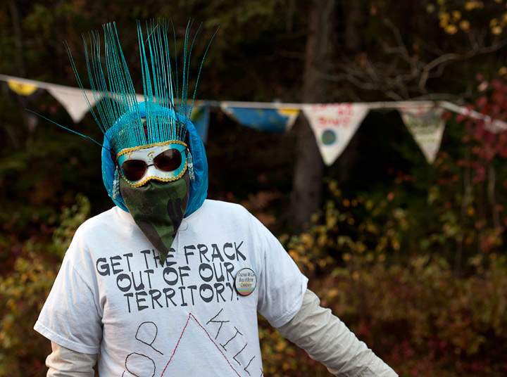 A protester is seen in Rexton, N.B. as police began enforcing an injunction to end an ongoing demonstration against shale gas exploration in eastern New Brunswick on Thursday, Oct.17, 2013. (Photo credit: The Canadian Press)