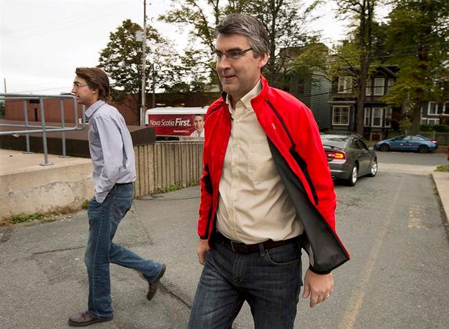 Nova Scotia Liberal Leader Stephen McNeil, accompanied by his son Jeffrey, left, makes a campaign stop in Halifax on Monday, Oct. 7, 2013. The Nova Scotia election is on Tuesday, October 8. 