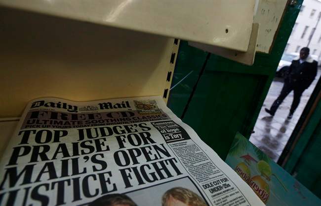 Copies of Britain's Daily Mail newspaper are offered for sale at a newsagent in London, Thursday, Oct. 3, 2013.