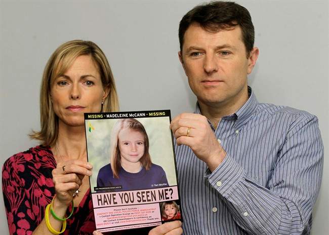 FILE - In this May 2, 2012 file photo, Kate and Gerry McCann pose for the media with a missing poster depicting an age progression computer generated image of their daughter Madeleine at nine years of age, to mark her birthday and the 5th anniversary of her disappearance during a family vacation in southern Portugal in May 2007, during a news conference in London.
