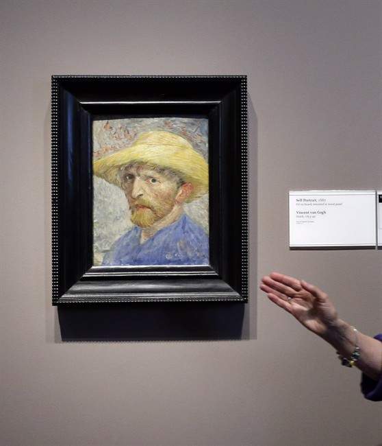 FILE- In a June 13, 2013, file photo, Detroit Institute of Arts docent Lea Schelke points out details in the Self-Portrait by Van Gogh displayed at the museum in Detroit. 