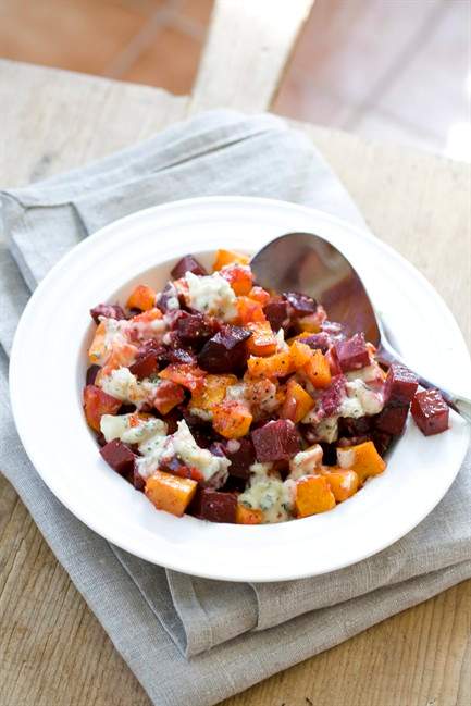 This Oct. 14, 2013 photo shows roasted squash and beets with creamed garlic in Concord, N.H. To soften its flavor, the garlic is cooked in a long, slow simmer in heavy cream, then pureed.