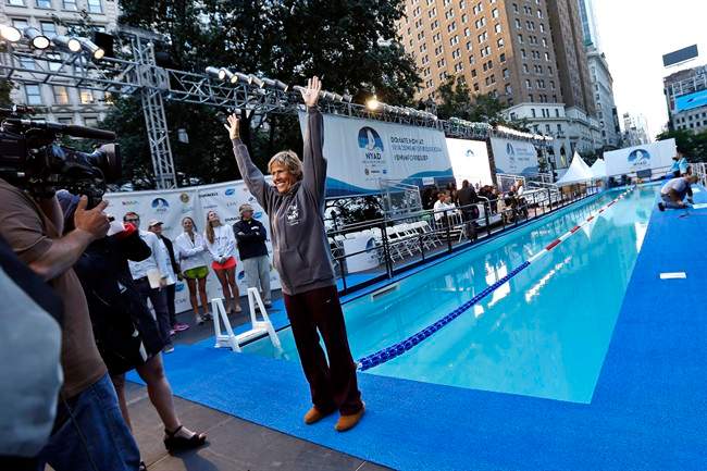 Long-distance swimmer Diana Nyad, who recently completed a record-breaking swim from Cuba to Florida, greets the media before beginning a continuous 48-hour marathon swim event in New York's Herald Square called "Swim for Relief," which aims to raise funds and awareness for Hurricane Sandy recovery efforts, Tuesday, Oct. 8, 2013. 