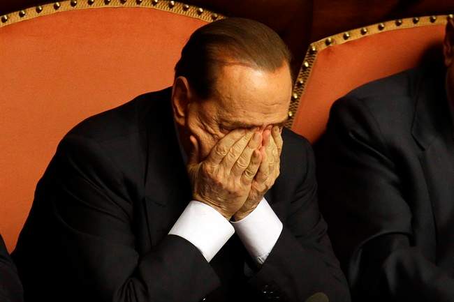 FILE - In this Wednesday, Oct. 2, 2013 file photo Silvio Berlusconi rubs his eyes after delivering his speech at the Senate, in Rome. 