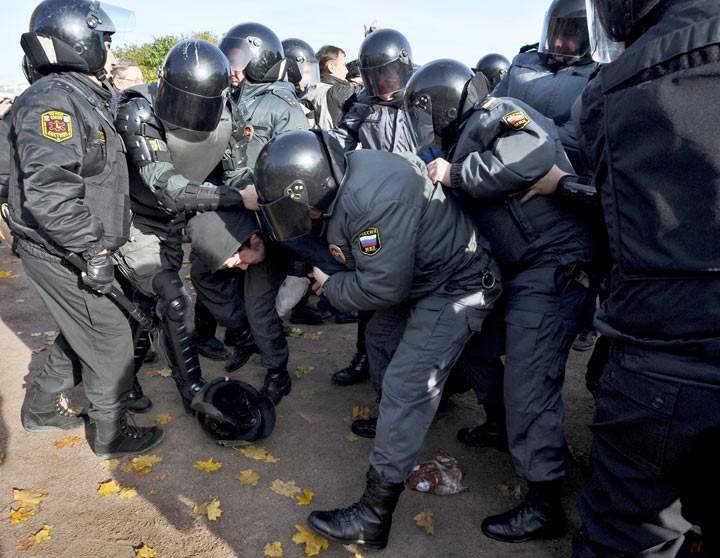 Russian OMON, riot police, officers detain an anti-gay protester (bottom L) during a gay pride event in Saint Petersburg on October 12, 2013. (OLGA MALTSEVA/AFP/Getty Images)