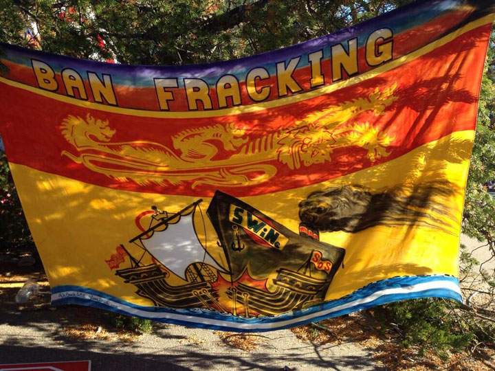 A New Brunswick flag with an anti-fracking message at a protest site near Rexton, N.B.