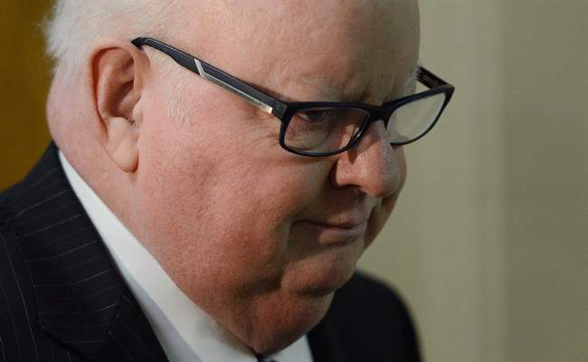 Senator Mike Duffy arrives on Parliament Hill in Ottawa on Oct. 22, 2013 as his colleagues debated his suspension.