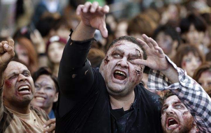 Former sumo grand champion Akebono, centre, and other participants in zombie costumes, perform during a Halloween event at Tokyo Tower in Tokyo, Thursday, Oct. 31, 2013. Shizuo Kambayashi / AP Photo