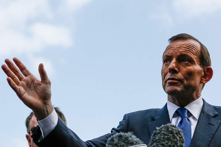 Australian Prime Minister Tonny Abbott talks with journalist at a press conference on October 9, 2013 in Kuta, Indonesia.
