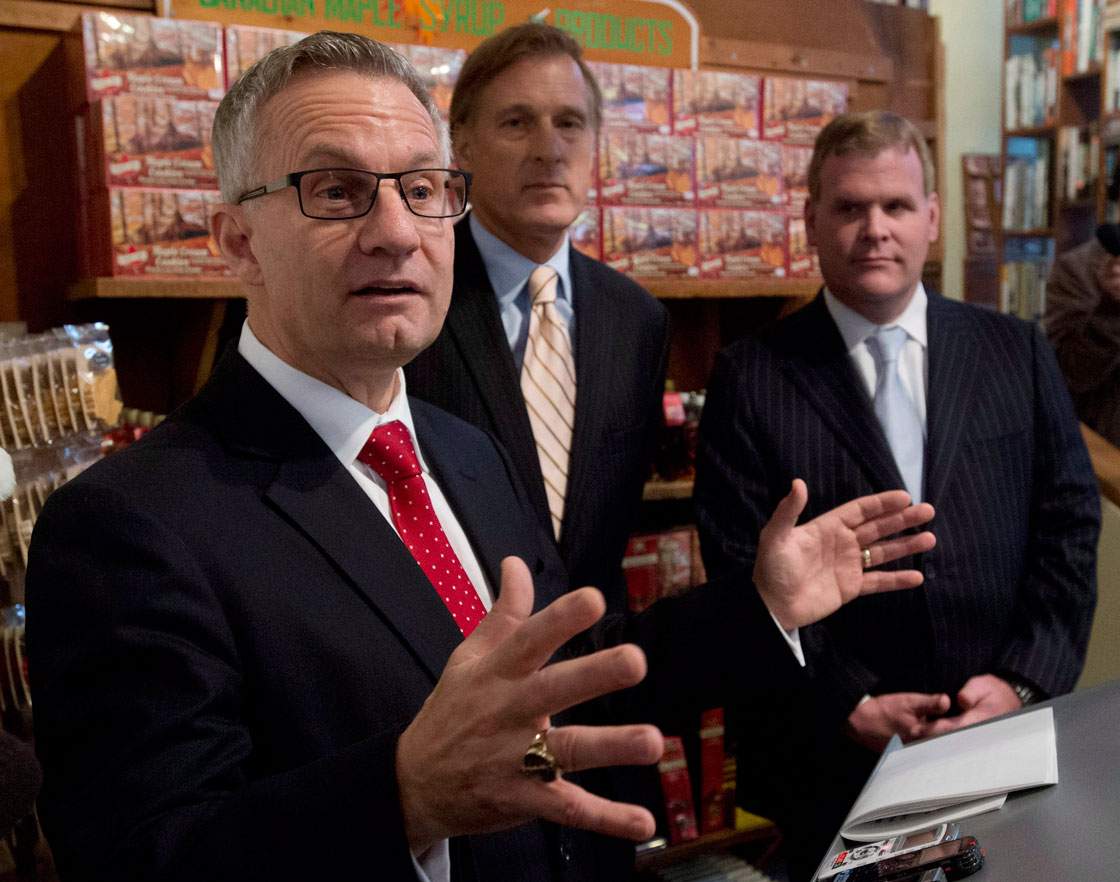 Flanked  by Minister of State Maxime Bernier and Minister of Foreign Affairs  John Baird, right, Federal International Trade Minister Ed Fast speaks to media in Ottawa on Monday.  
