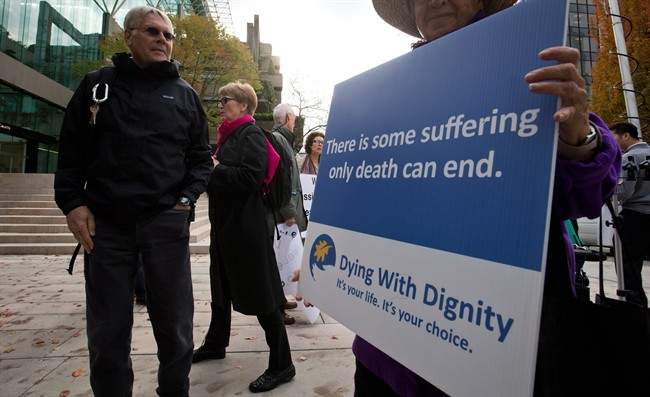 Hollis Johnson, left, and his wife Lee Carter leave the B.C. Court of Appeal after the court reversed a lower court ruling that said Canada's assisted-suicide ban violated the charter rights of gravely ill Canadians, in Vancouver, B.C., on Thursday October 10, 2013. 