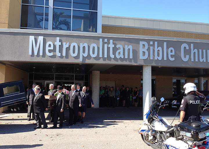 An honour guard is seen at the funeral of Dave Woodard. Woodard was killed when the bus he was driving collided with a VIA rail train on September 6, 2013.