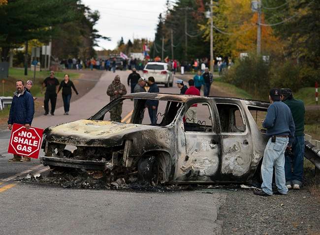 A burned police vehicle is seen in Rexton, N.B. as police began enforcing an injunction to end an ongoing demonstration against shale gas exploration on Oct.17, 2013.