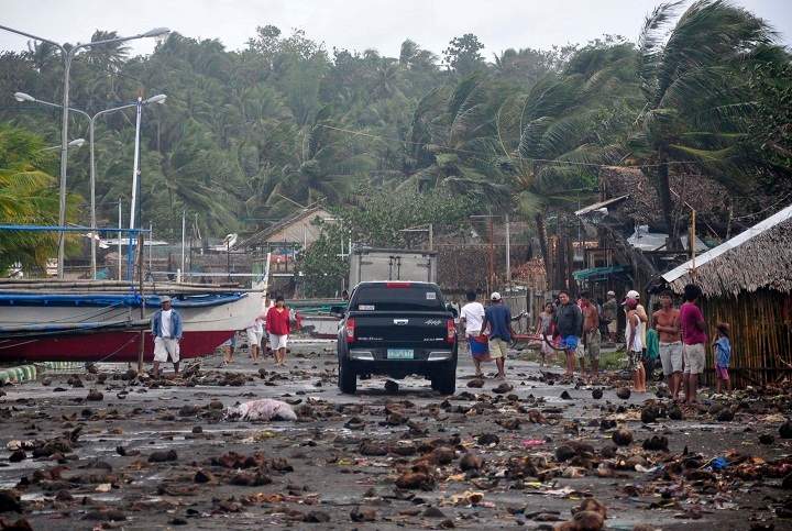 Debris litter the road by the coastal village in Legazpi city following a storm surge brought about by powerful Typhoon Haiyan in Albay province. (AP Photo/Nelson Salting)