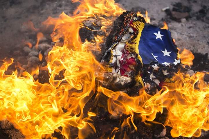 A flag is burned during a flag retirement ceremony Sunday, Nov. 10, 2013, in front of the USS LST 393 Veterans Museum in Muskegon, Mich. (AP Photo/The Muskegon Chronicle, Natalie Kolb)