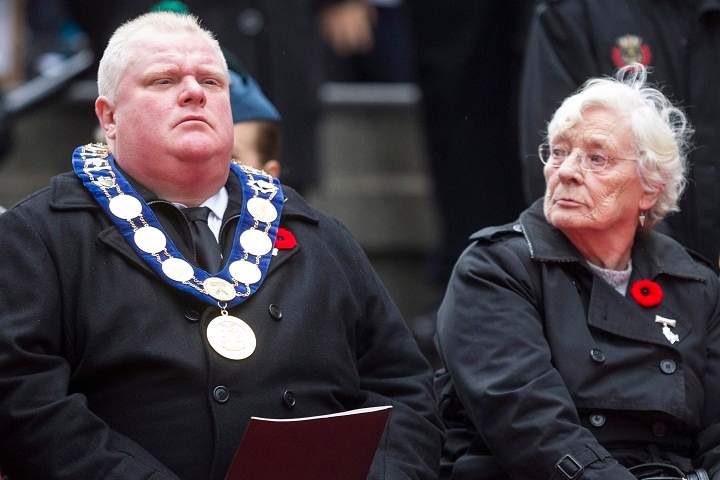 Margaret Delmore (left), the ceremonial Memorial Cross Mother, sits next to Toronto Mayor Rob Ford at the cenotaph during the Remembrance Day service in Toronto on Monday, November 11, 2013. (The Canadian Press/Chris Young)