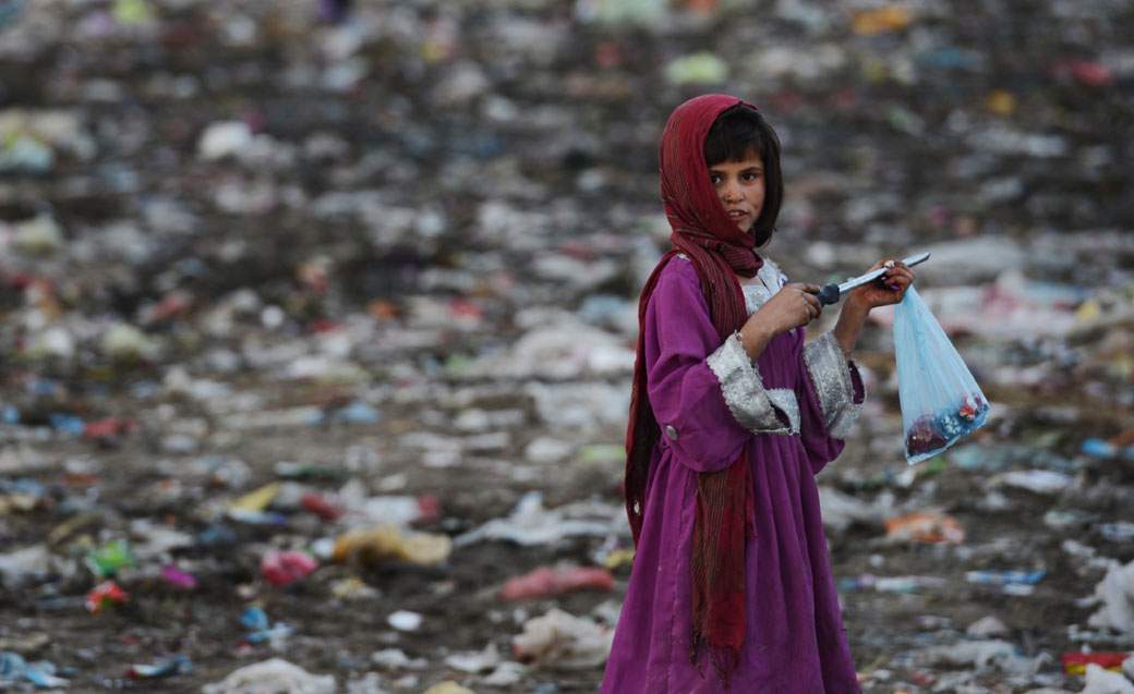 A young Afghan garbage collector looks on from a landfill in the outskirts of Kabul on October 17, 2012. (Jawad Jalali/AFP/Getty Images)