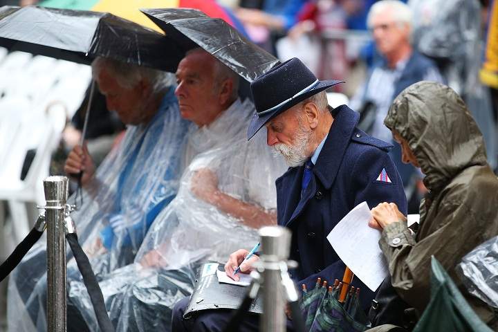 People gather to pay tribute at the Cenotaph during the Rememberance Day Service held at the Cenotaph, Martin Place on November 11, 2013 in Sydney, Australia. (Brendon Thorne/Getty Images)