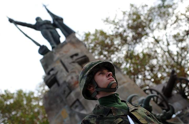 A Serbian Army soldier stands at attention in front of a monument on November 11, 2013 during a Remembrance Day ceremony, marking the 99th anniversary of the end of World War I at the French Soldiers Cemetery in Belgrade. (Andrej Isakovic/Getty Images