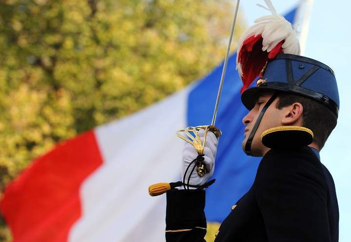 A French officer stands at attention in front of a French flag on November 11, 2013 during a Remembrance Day ceremony, marking the 99th anniversary of the end of World War I at the French Soldiers Cemetery in Belgrade. (Andrej Isakovic/Getty Images)