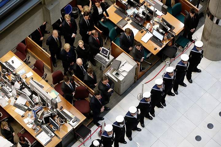 Members of the Royal Navy form an honour guard as brokers and underwriters line the balconies and escalators of the Lloyd’s of London building during a service on November 11, 2013 in London, England. The annual Armistice Day service honours those who have lost their lives during times of war. The service at Lloyd’s is observed with the ringing of the Lutine Bell, the laying of wreaths before the Book of Remembrance and a two minute silence. (Matthew Lloyd/Getty Images)