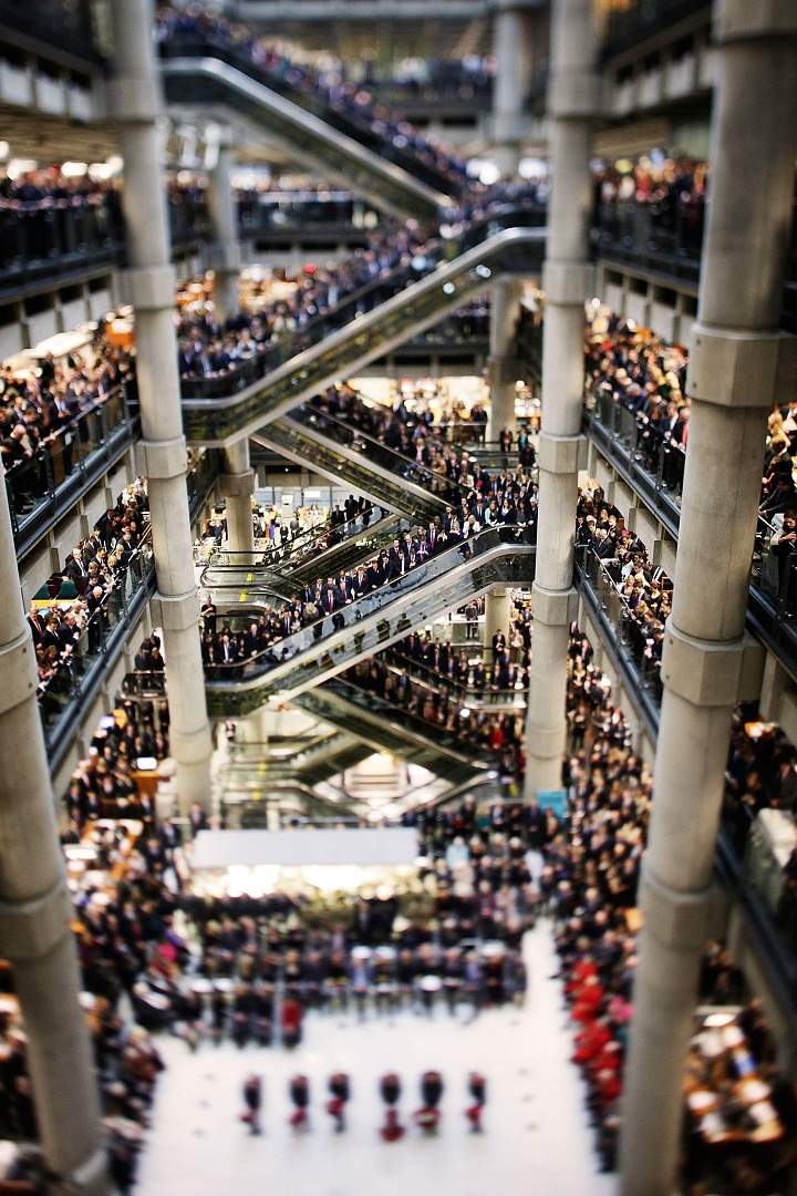Brokers and underwriters line the balconies and escalators of the Lloyd’s of London building as a choir sings during a service on November 11, 2013 in London, England. The annual Armistice Day service honours those who have lost their lives during times of war. The service at Lloyd’s is observed with the ringing of the Lutine Bell, the laying of wreaths before the Book of Remembrance and a two minute silence. (Matthew Lloyd/Getty Images)
