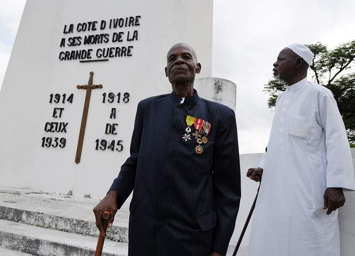 Ivorian World War II veterans pose in front of a monument in memory of WWI and WWII soldiers on November 11, 2013 in Abidjan during the Armistice Day ceremonies marking the end of World War I. (Sia Kambou/Getty Images)
