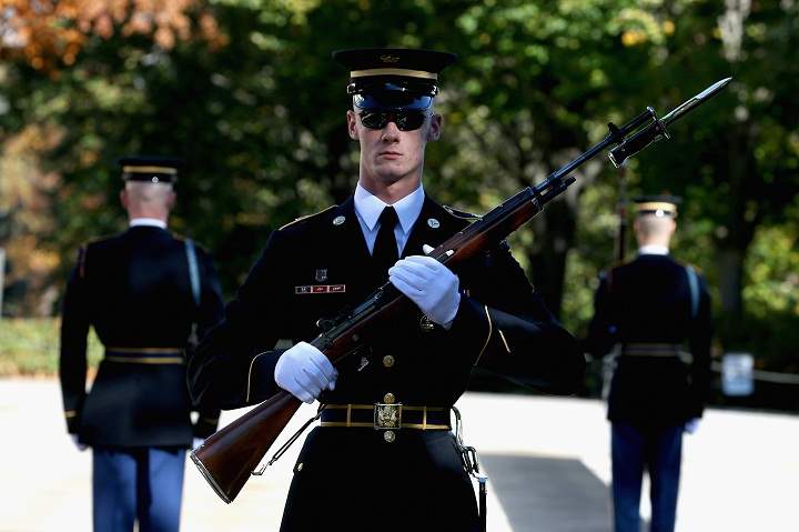 Members of the military color guard stands at attention before a ceremony where U.S. President Barack Obama will lay a commemorative wreath for Veterans Day at the Tomb of the Unknowns at Arlington National Cemetery on November 11, 2013 in Arlington, Virginia. (Mark Wilson/Getty Images)
