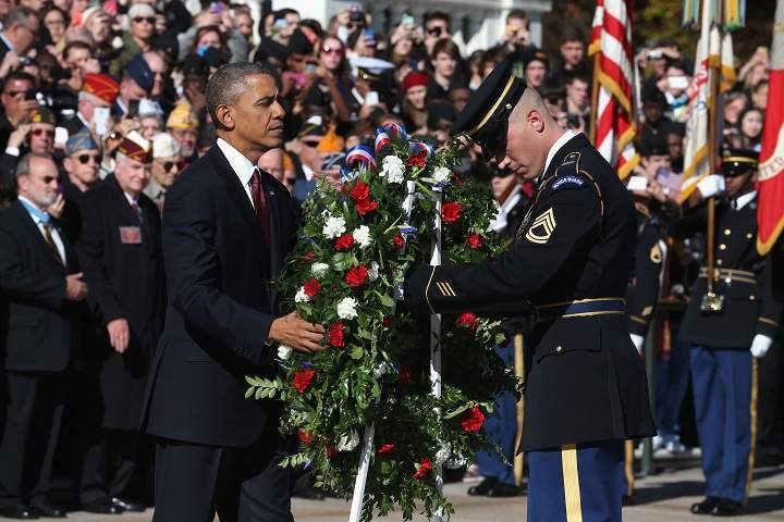 President Barack Obama positions a commemorative wreath during a ceremony on Veterans Day at the Tomb of the Unknowns at Arlington National Cemetery on November 11, 2013 in Arlington, Virginia. (Mark Wilson/Getty Images)
