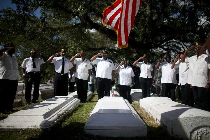 Military veterans salute during a Veterans Day ceremony held in the Grove Bahamian Cemetery on November 11, 2013 in Coconut Grove, Florida. (Joe Raedle/Getty Images)
