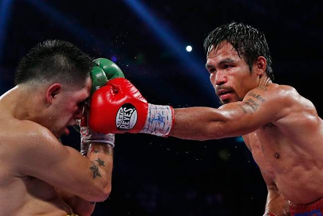 Manny Pacquiao, from the Philippines, right, lands a left to the head of Brandon Rios of the United States during their WBO international welterweight title fight Sunday, Nov. 24, 2013, in Macau.