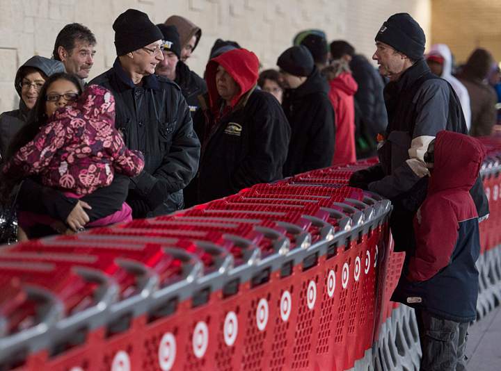 Shoppers wait in line at the Target store in Dartmouth, N.S. on Friday, Nov. 29, 2013. Black Friday, the most important shopping day of the year in the United States, is having an impact on Canadian sales as retailers work to keep consumers home, north of the border. (Photo credit: Andrew Vaughan/The Canadian Press)