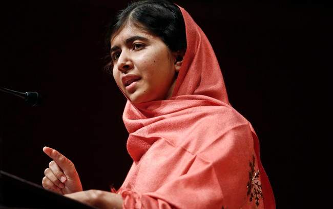 In this Friday, Sept. 27, 2013 file photo, Malala Yousafzai addresses students and faculty after receiving the 2013 Peter J. Gomes Humanitarian Award at Harvard University in Cambridge, Mass. 