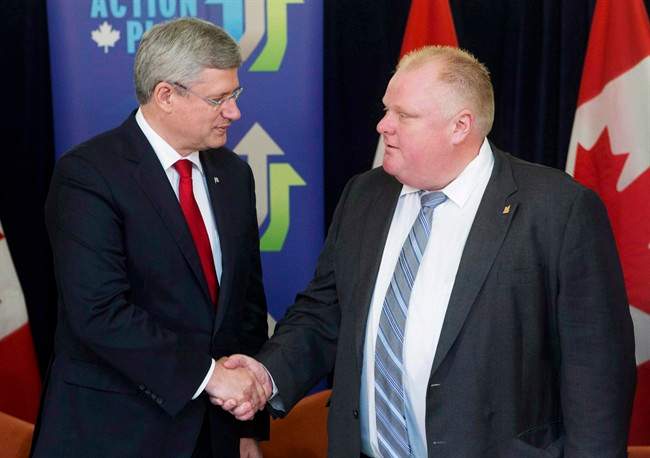 Prime Minister Stephen Harper shakes hands with Toronto Mayor Rob Ford after announcing funding for new subways in Toronto, Sunday, September 22, 2013. Harper appears to be among the few living souls with no opinion on the Toronto mayor’s spectacular fall from grace.