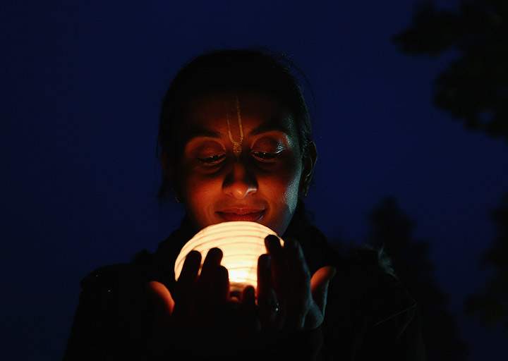 A woman holds a lantern during Diwali celebrations at Bhaktivedanta Manor on November 3, 2013 in Watford, United Kingdom. The festival is an opportunity for Hindus to honour Lakshmi, the goddess of wealth and other gods. Leicester's celebrations are one of the biggest in the world outside India. (Photo credit: Getty Images).