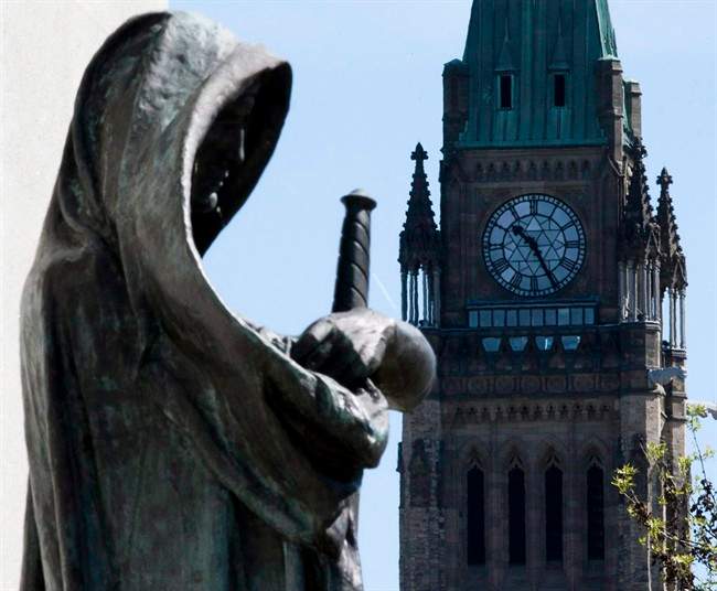 "Truth", left, the statue at the entrance of the Supreme Court of Canada in Ottawa, is shown on May 7, 2010. 