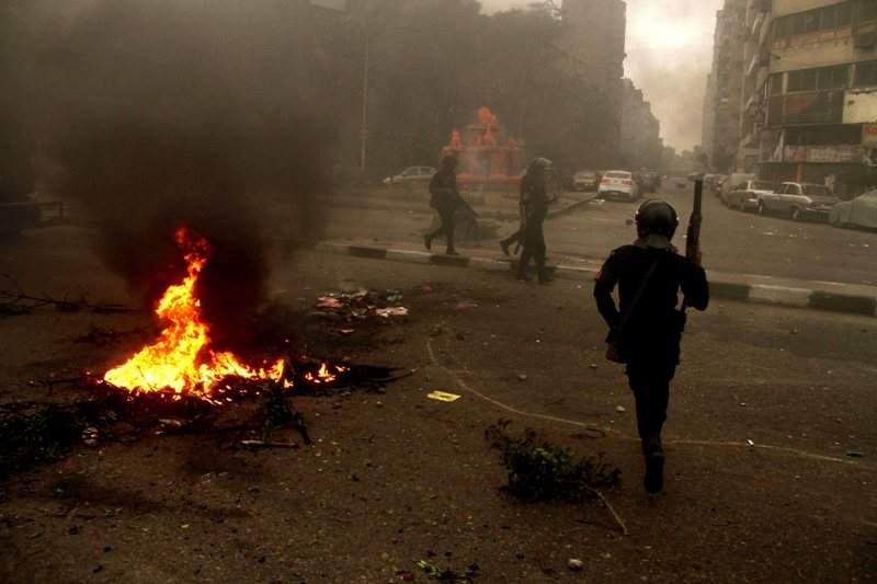 Egyptian riot police move to disperse a protest against a new law regulating demonstrations in Cairo, Egypt, Friday, Nov. 29, 2013. (AP Photo/Ahmed Gomaa)