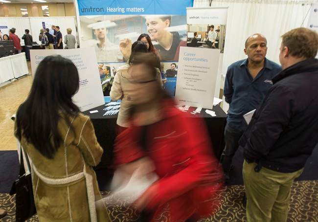 ob seekers talks with staff at the Kitchener, Ontario based hearing aid technology firm Unitron at the company's booth at the Communitech Tech Jobs   recruitment event in Waterloo Ontario.