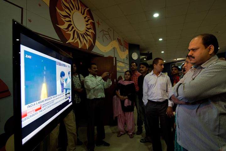 Indian visitors to the Nehru Planetarium watch the live telecast of the launch of India's Mars Orbiter Mission in New Delhi on November 5, 2013 .