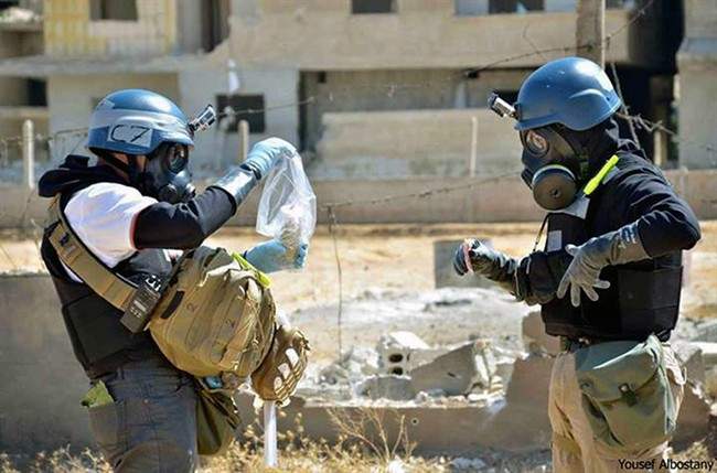United Nations investigators take sand samples near suspected chemical rocket, Ain Terma, Syria, Aug. 28, 2013.