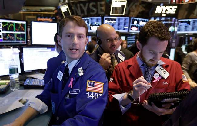 Specialist Peter Elkins, left, works with traders Luigi Muccitelli, center, and Timothy Pastina on the floor of the New York Stock Exchange, Wednesday Nov. 6, 2013. Stocks rose in early trading Wednesday, sending major indexes back to record highs, as traders anticipated that the Federal Reserve will keep up its stimulus program for some time. (AP Photo/Richard Drew)