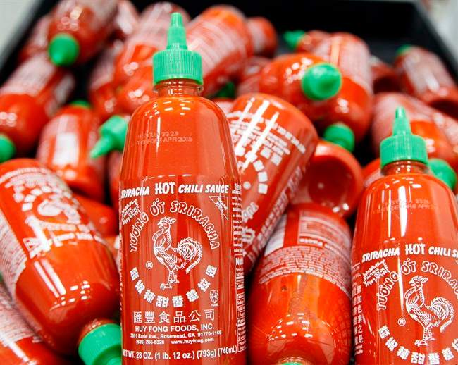In this Tuesday, Oct 29, 2013, file photo, Sriracha chili sauce bottles are produced at the Huy Fong Foods factory in Irwindale, Calif. 