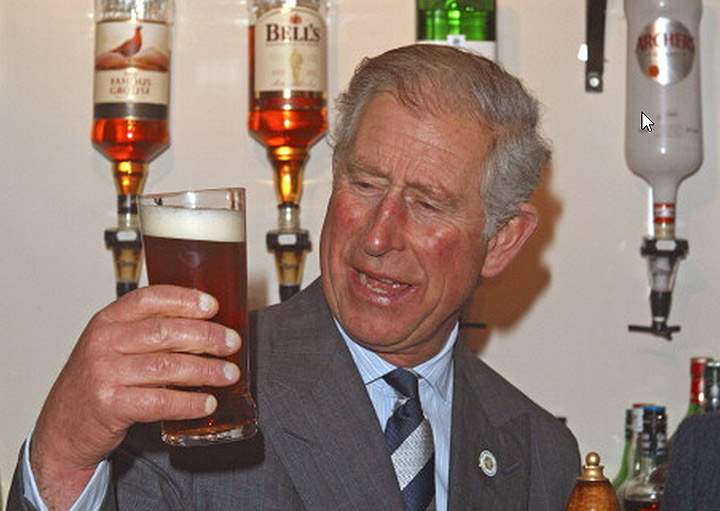 Prince Charles, Prince of Wales holds a pint of ‘Newton’s Drop’ beer which he ‘pulled’ during a visit to the Cholmeley Arms pub in Burton-le-Coggles on November 29, 2011 in Grantham, England. (Photo credit: Getty Images)