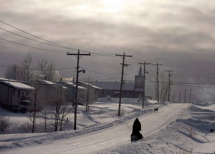 A snowmobile rides down the main street Tuesday, December 18, 2012, on the Fort Hope First Nation, Ont. THE CANADIAN PRESS/Ryan Remiorz.