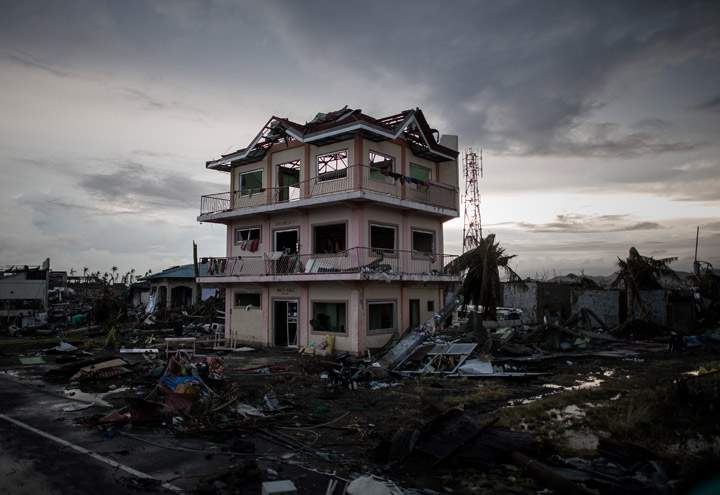 A the sun sets over a house damaged by Typhoon Haiyan outside the airport in Tacloban, on the eastern island of Leyte on November 12, 2013 after Super Typhoon Haiyan swept over the Philippines.  (Photo credit: Getty Images)