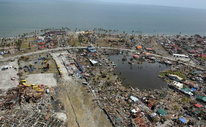 This aerial photo shows destroyed houses in the city of Tacloban, Leyte province, in the central Philippines on November 11, 2013, only days after Super Typhoon Haiyan devastated the town on November 8. (Photo credit: Getty Images)