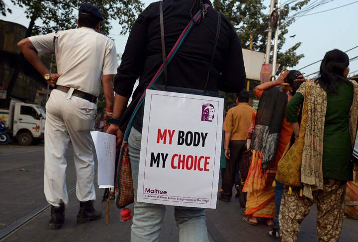 Indian social activists take part in a rally on the International Day for the Elimination of Violence against Women in Kolkata on November 25, 2013. (Photo credit: Getty Images)