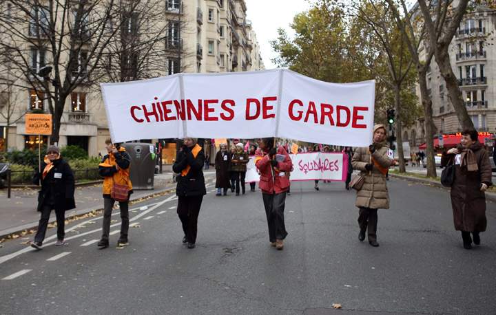 Activists from French feminist ‘Chiennes de garde’ association (Guard dogs) hold a banner during a demonstration for the abolition of prostitution and the elimination of violence against women called by the Women rights national collective, on November 23, 2013 in Paris. (Photo credit: Getty Images)